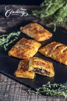 four pastries sitting on top of a black plate