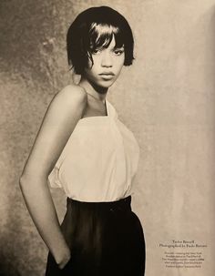 a black and white photo of a woman with short hair