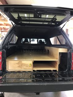 the back end of a truck with its cargo compartment open