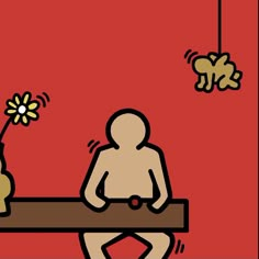 a person sitting at a table with a flower in front of them and an object hanging from the ceiling