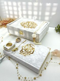 a white box with gold designs on it and some other items next to the box