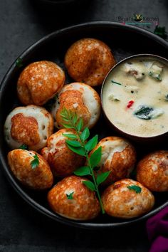 a bowl filled with some kind of food next to a small bowl of dip sauce