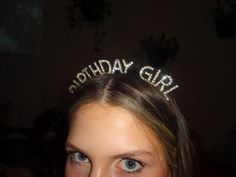 a woman wearing a tiara with the words happy birthday girl on it's head