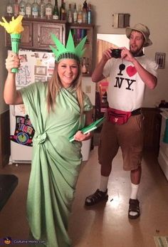 two people dressed up as the statue of liberty and lady liberty, one in a green dress