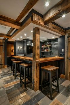 a home bar with stools in the middle and an open floor plan on the other side