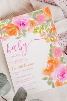 a baby shower with pink and orange flowers on the front, in watercolor style