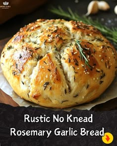 a close up of a bread on a plate with rosemary sprigs and garlic