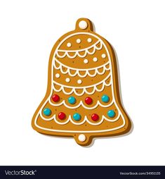 a gingerbread christmas ornament with candy on it's side and a bell hanging from the top