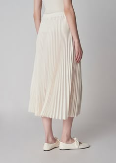 An easy pleated skirt rendered in Japanese stretch crepe. Clean minimalist elastic waistband. Calf length. Details Ivory 81% Triacetate, 19% Polyester 3028FATP-ESSN True to size Model is 5'11" and wears a size Small. Elastic Waist Skirt, Stretch Crepe, Pleated Skirt, Waist Skirt, Elastic Waist, Elastic, Skirt, How To Wear