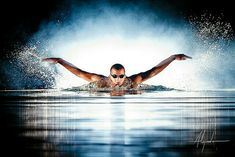 a man swimming in the water with his arms spread out