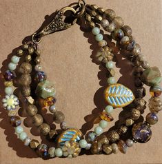 Three beautiful strands of Czech glass flowers, leaves and pressed beads with bronze finish findings and lobster clasp. Cheap Adjustable Czech Glass Bracelets, Czech Beads Jewelry, Bracelet Inspo, Glass Bracelet, Glass Flowers, Bead Jewelry, Flowers Leaves, Czech Beads, Etsy Jewelry