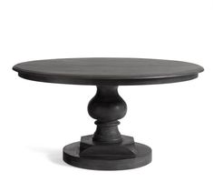 a round table with an iron base and black wood top, on a white background