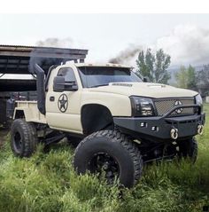 a white truck is parked in the grass