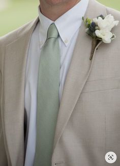 a man in a suit with a flower on his lapel