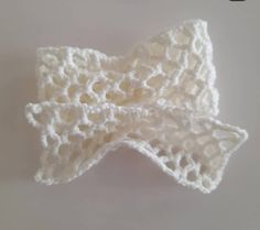 a crocheted white bow on a white background