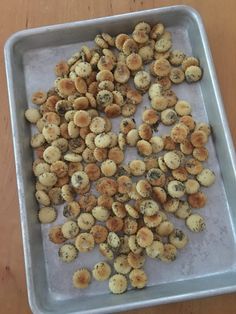 a pan filled with food sitting on top of a wooden table