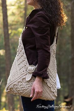 a woman carrying a crocheted purse in the woods