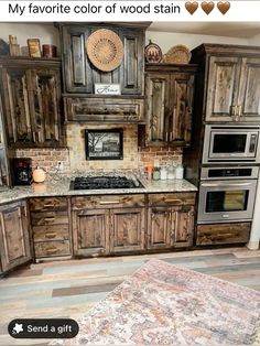 a kitchen with wooden cabinets and an area rug in front of the stove top oven