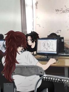 two people sitting in front of computer screens with anime characters on the screen and behind them