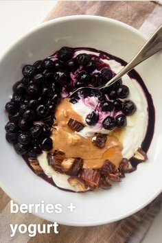 berries and yogurt in a white bowl with a spoon