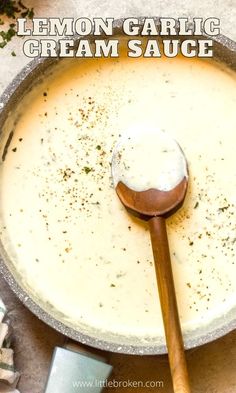 a wooden spoon is in a pan filled with soup