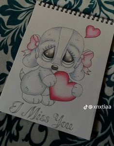 a drawing of a little bear holding a heart with the words i miss you written on it