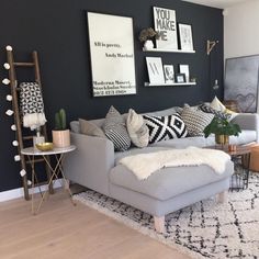 a living room filled with lots of furniture and pictures on the wall above it's couch