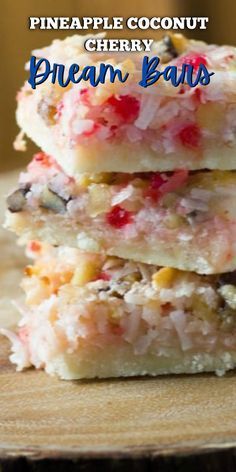 three pieces of pineapple coconut cherry pecan bars stacked on top of each other