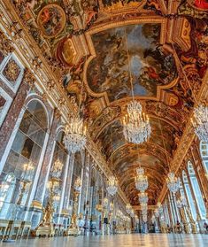 an ornate room with chandeliers and paintings on the ceiling