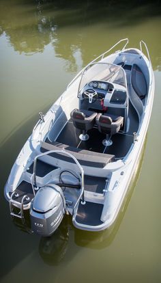 a small motor boat is parked in the water