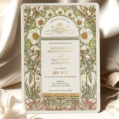 an ornate wedding card with flowers on it