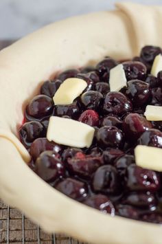 blueberries and cheese are in a pie pan