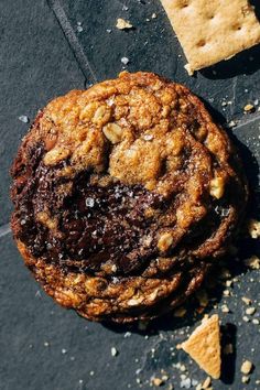 a chocolate chip cookie sitting on top of a table