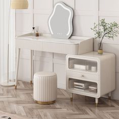 a white dressing table with a mirror and stool next to it on a wooden floor