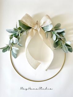 a white plate topped with a bow and greenery