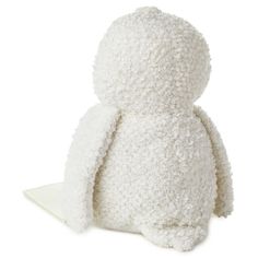 a white stuffed animal sitting on top of a table