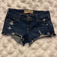 Super Cute, Dark Blue, High Rise Shorts With A Little Silver Stitched Flower On The Lower Left Side. Never Worn And In Excellent Condition Blue Y2k Jean Shorts, Hollister Low Rise Jeans, Hollister Pj Shorts, Hollister Low Rise Shorts, Vintage Hollister, Hollister Blue Babydoll Top, Low Rise Shorts, Hollister Shorts, High Rise Shorts