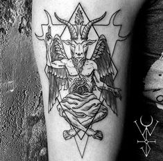 a black and white photo of a tattoo design on the left leg, with an image of a demon