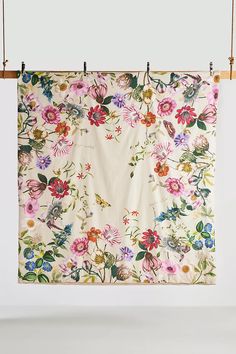 a floral print hanging on a clothes line