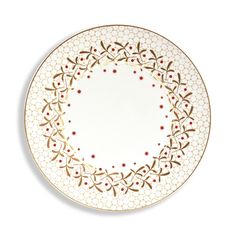 a white plate with gold trim and red flowers on the rim, against a white background