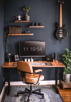 a home office with a guitar on the wall and a desk in front of it