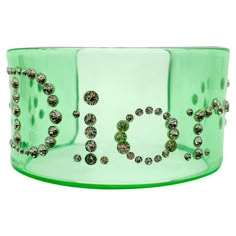 A Vintage Dior Apple Cuff from the Galliano era. Featuring a broad apple green lucite cuff studded with crystals spelling out the name of the iconic House of Dior. With archive pieces from her own Dior collection displayed in London's highly acclaimed Dior Designer of Dreams Exhibition, Jennifer understands what it’s like to be on the hunt for your perfect piece of Dior heritage. She has sourced and curated these strikingly beautiful collection of vintage Christian Dior jewels, including this on Dior Designer Of Dreams, Fashion Collection Inspiration, Bracelets Pink, Couple Bands, Bottle Cap Necklace, Collage Materials, Designer Costume Jewelry, Aesthetic Dump, Dior Collection