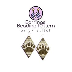 the earrings are made with brown and white beading, which has a paw print on it