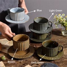 three coffee cups and saucers sitting on top of a table next to each other