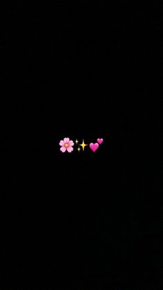 two pink flowers are in the dark with stars on it's side and one is yellow