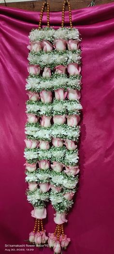 pink and white cupcakes are arranged in the shape of a vertical column on a purple background