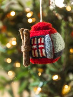 a knitted ornament hanging from a christmas tree