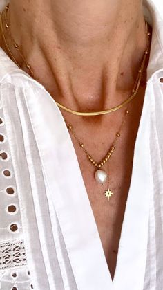 It's all in the detail for this gorgeous two-layer necklace in 14K gold-plated stainless steel, adorned with a Freshwater Pearl and a hanging star. It's perfect for dressing up or adding a touch of glamour to your everyday style Length: 15 to 17 inches with extender Elegant Chain Necklace With Star Charm, Elegant Gold Chain Necklace With Star Charm, Elegant Gold Necklace With Star Charm, Gold Plated Necklaces With Star Charm, Layered Pearl Necklace, Layer Necklace, Dressing Up, Guinea Bissau, Everyday Style