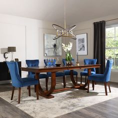 a dining room table with blue chairs around it