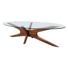 an oval glass table with wooden legs and a wood base, on a white background